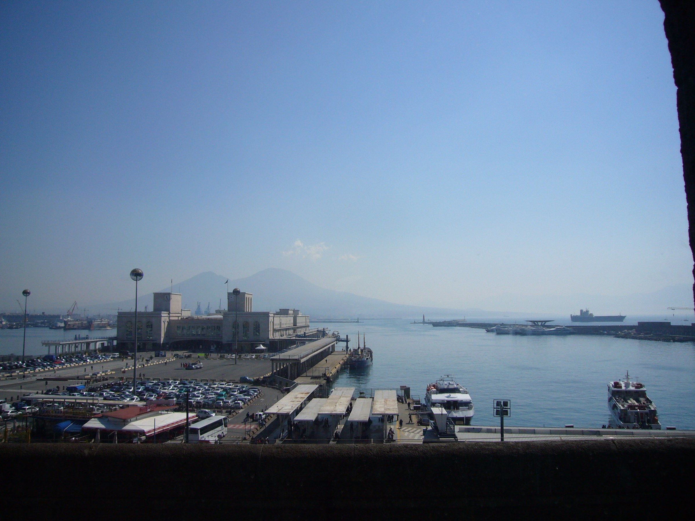 The Stazione Marittima and the harbour towards the Molo Beverello, where the Molo Grande stood, seen from Castel Nuovo. Photo Lalupa, Wikimedia Commons, CC BY-SA 4.0.